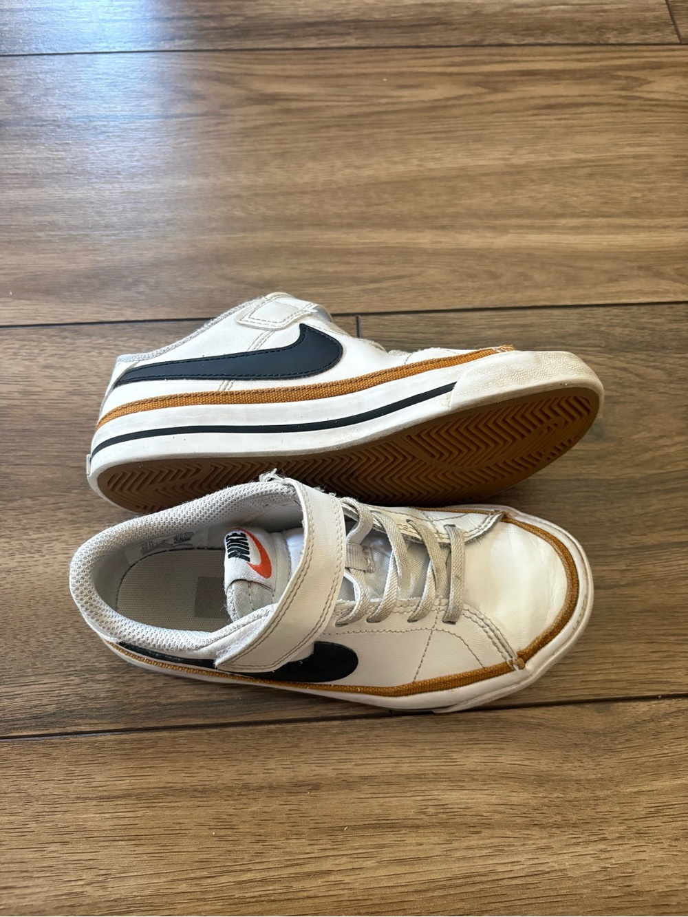 Nike Kids White Sneakers with Black Swoosh and Tan Accents